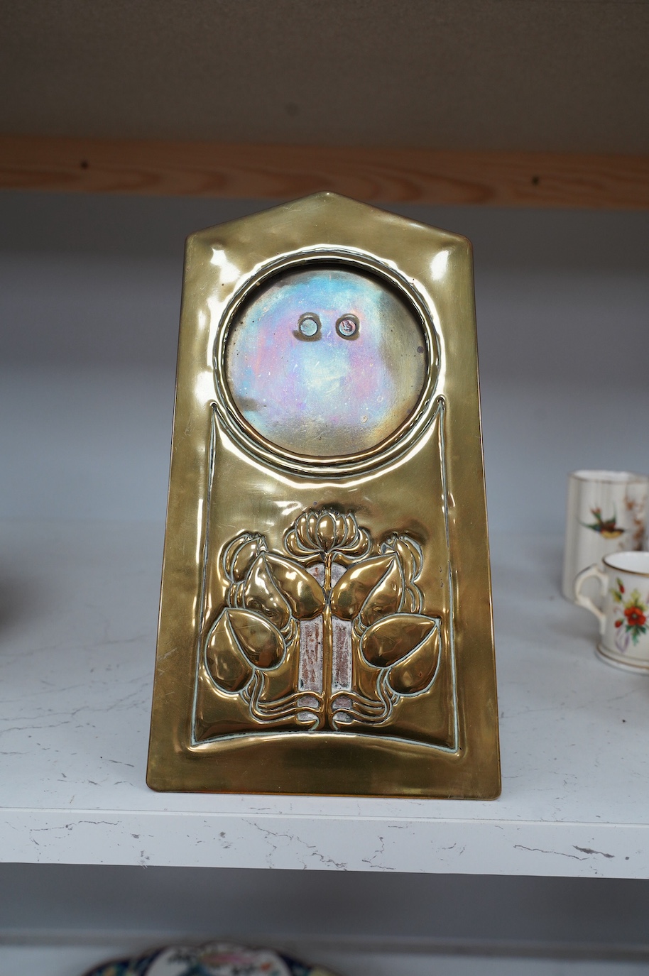 An Art Nouveau embossed brass easel photograph frame, 26cm tall. Condition - fair to good